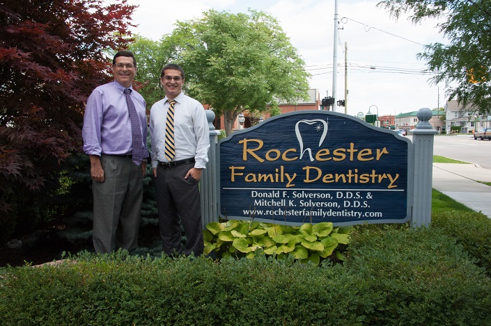 Drs Don & Mitch in front of office sign